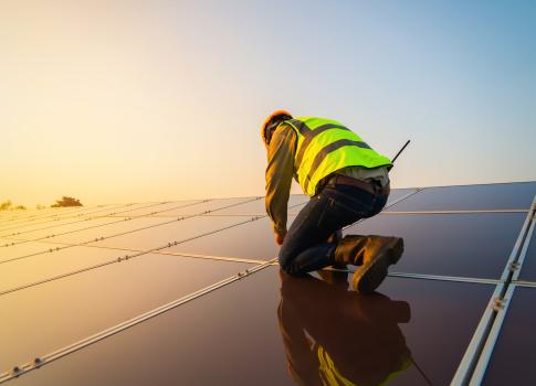 worker installing solar 