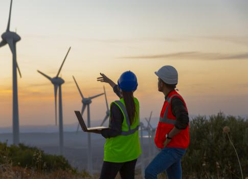 engineers looking at a wind turbin