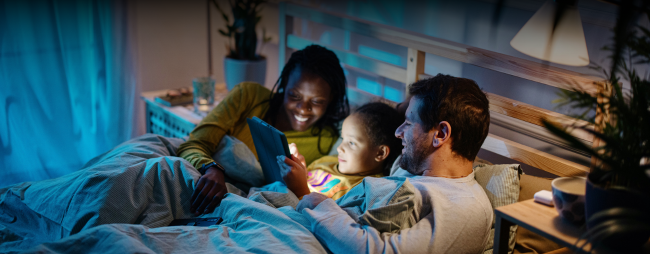 family watching an ipad in bed at night